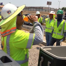Department of Transportation workers in Arizona take a hydration break while doing road work