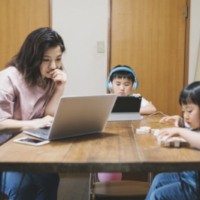Mother and children on their digital devices.