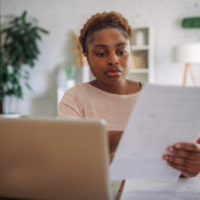 A young Black woman sitting at a desk, working attentively on a laptop Unemployment Insurance, Unemployment, Unemployment benefits, Saftey Net, UI System, UI benefits, Federal Workers, Fix UI, unemployment insurance eligibility, unemployment claims