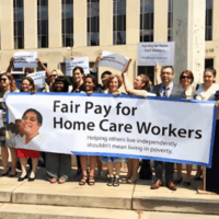 A group of homecare worker advocates hold a banner that reads "Fair Pay for Home Care Work"