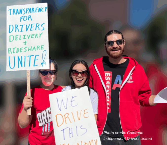 A trio of advocates with Colorado Independent Drivers United carry signs that read, "Transparency for Drivers -Delivery, and Rideshare Unite!" and "We Drive This Economy".
