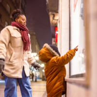 Mother and child holiday window shopping.
