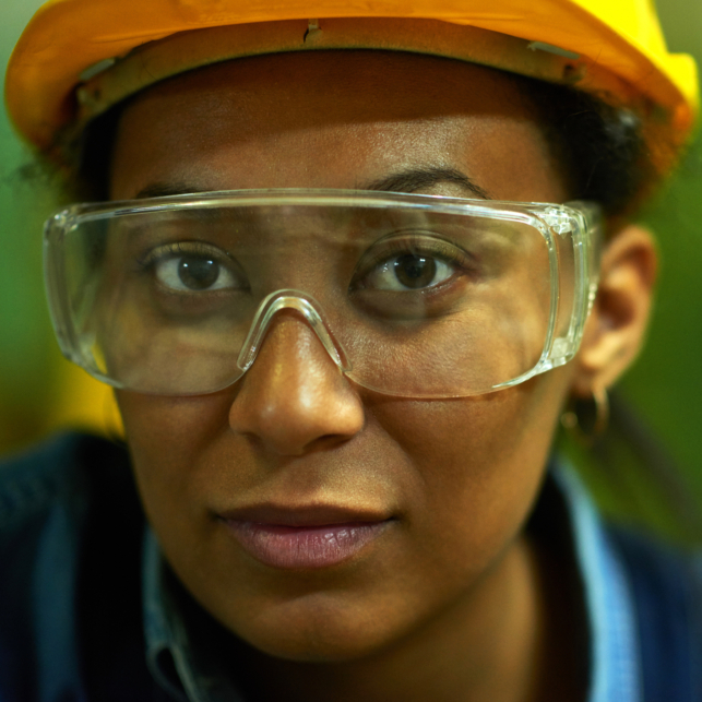 Close-up of face of a worker in goggles and hardhat