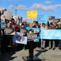 App-based workers and advocates gather at the U.S. Capitol holding signs and banners urging passage of the Empowering App‑Based Workers Act, calling for higher wages and increased transparency for workers.